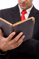 young businessman reading an old law book, shallow dof