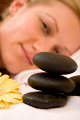 Obraz na płótnie Canvas beautiful woman happy with stone massage at spa center