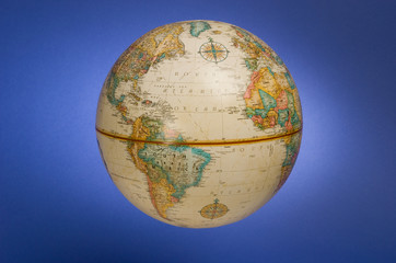 a globe of the earth against a blue background