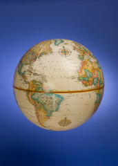 a globe of the earth against a blue background