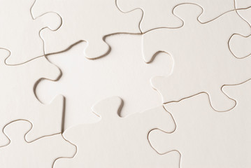 a nearly completed puzzle with a missing piece