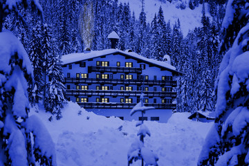 A hotel located in mountains covered by deep snow