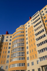 Fototapeta premium The orange monolith new-built on the sky background