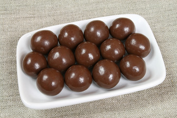 Tasty, sweet chocolate balls. Swets on a plate.