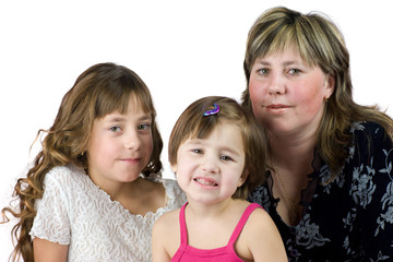 Mother with two daughters posing together isolated on white