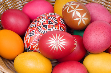 Colorful Easter eggs in straw basket