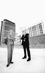 executive man and woman on a downtown roof