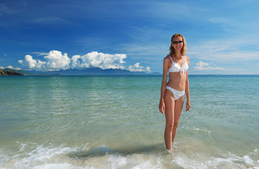 Girl on a tropical beach in the sea