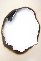 Burn hole in manila paper.