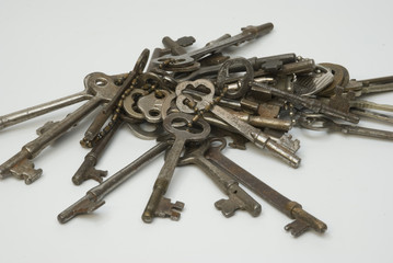 Bundle of old keys on a white background