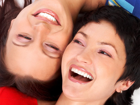 Happy young women friends laughing.