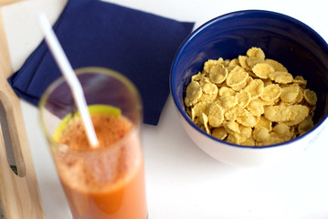 Easy breakfast from corn-flakes and carrots juice