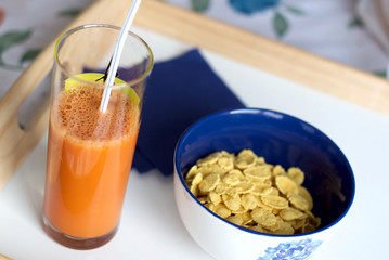 Easy breakfast from corn-flakes and carrots juice