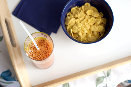 Easy breakfast from corn-flakes and carrots juice