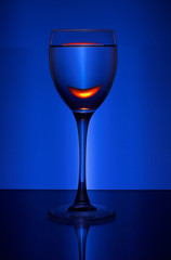 wineglass with wine on the color background