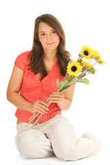 Beautiful teenage girl holding bunch of sunflowers 