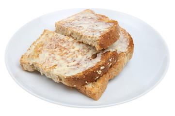 Fototapeta na wymiar Wholemeal toasted bread with butter