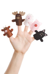 Girl wearing five finger puppets (pig, cat, cow, moose, lamb)