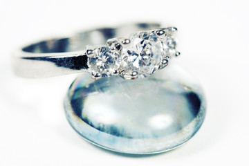 Engagement Ring taken closeup on glass pebble