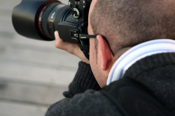 Photographer in black. Cam, flash and man.