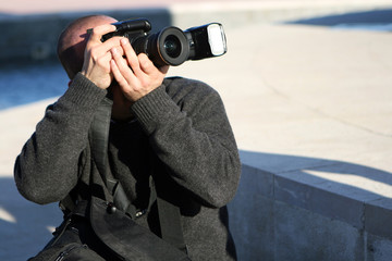 Photographer in black. Cam, flash and man.
