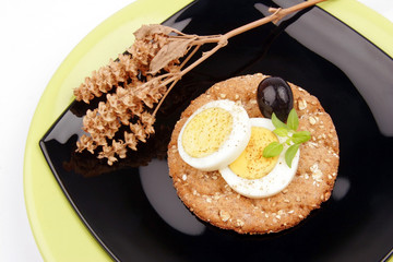 healthy meal with fiber egg black olive and dry basil decoration