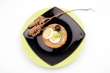 healthy meal with fiber egg black olive and dry basil decoration