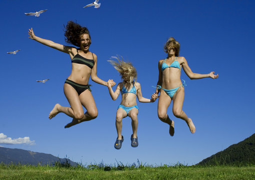 two girls having fun with a child.