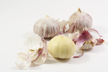 Three bulbs of garlic with peel on white