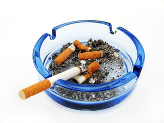 Blue glass ashtray with cigarette