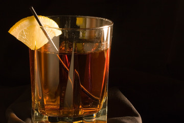 Cocktails, drinks, and alcohol in a colored glass at a bar