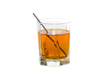 Isolated cut glass filled with a strong whiskey drink