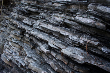 Aligned stones forming a pattern on a cliff