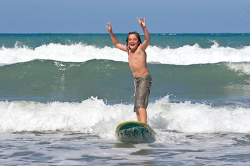 A young caucasian male learns to surf