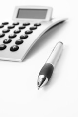 Pen and calculator (business background)