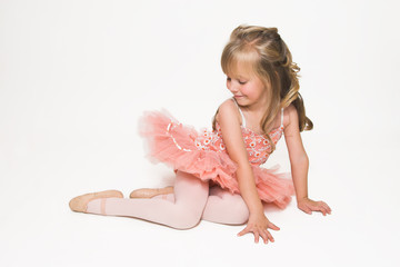 Young ballet dancer wearing an apricot tutu
