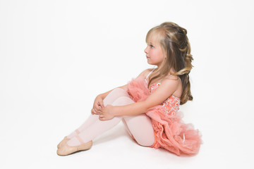 Young ballet dancer wearing an apricot tutu