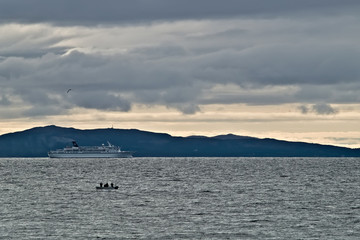 Cruise liner and fishing boat in Northern Norway