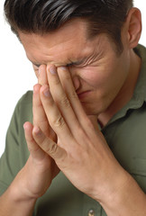 Young man suffering from a painful headache