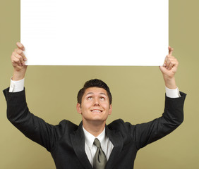 Businessman holding a sign that is easily exandable for copy 