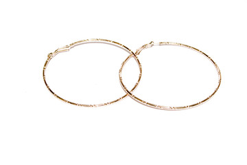 Obraz premium golden ear-rings on the white isolated background