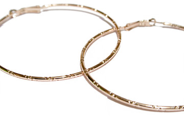 golden ear-rings on the white isolated background
