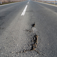 Damaged asphalt road