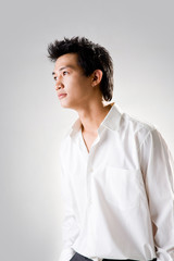 young man look up thinking with white shirt