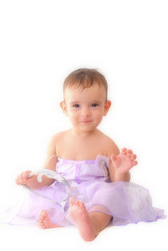 A baby girl in a fairy dress, wearing a crown, white background.