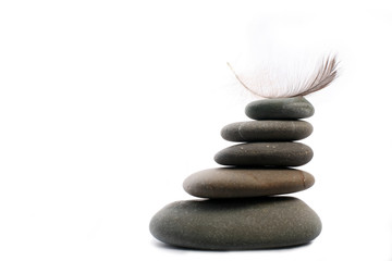 five Zen stones with feather