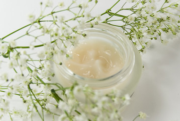 face creme and white flowers