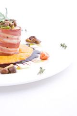 Dish with meat of the rabbit wrapped up by bacon