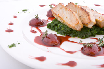 Dish from a tuna, grapes, sauce and greens, lemon and tomato 