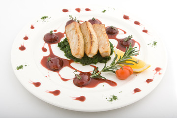 Dish from a tuna, grapes, sauce and greens, lemon and tomato